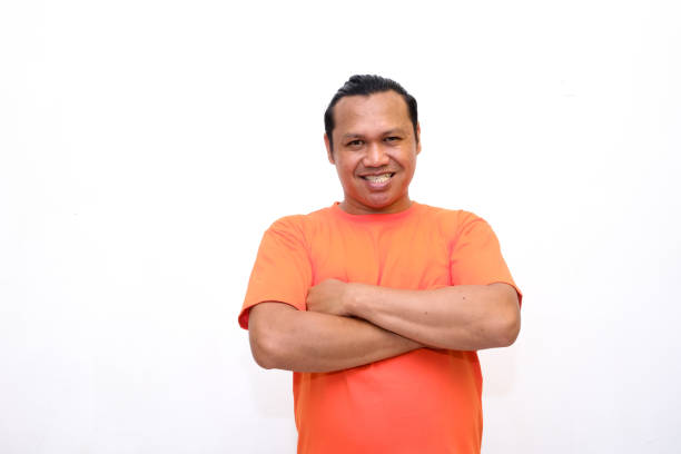 istock confident asian man standing while folding his arms across his chest 2148313986