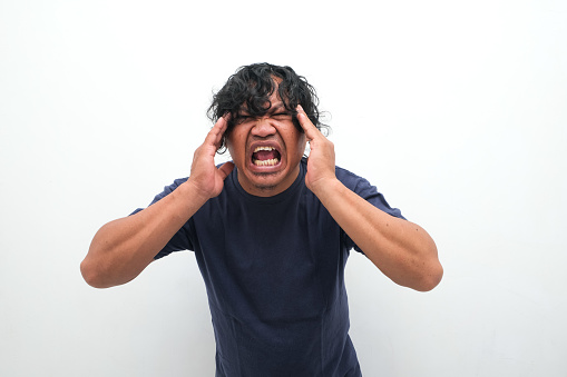 Asian man's expression feeling headache