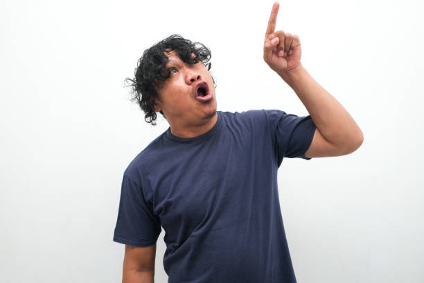 istock shocked Asian man pointing upwards 2148314541