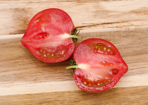 Round Pink tomato with a nose that produces heart shape when cut in half