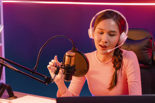 istock Smiling creative young beautiful Asian influencer talking in channel. Stratagem. 2148315142