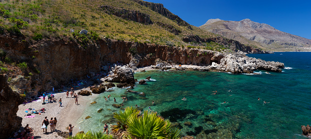Scopello, Italy - July 30, 2023: Disa inlet in Zingaro natural reserve on the shore of Castellammare Gulf on Sicily Island