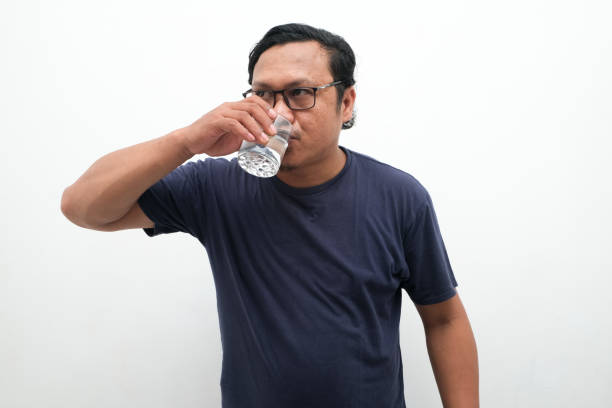 istock Asian man is drinking water from a glass 2148315524