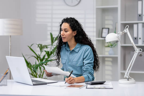 istock Hispanic businesswoman working from home office setup 2148316309