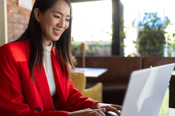 istock Businesswoman using laptop while working in coffee shop 2148316728