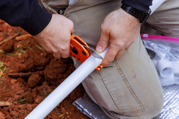 istock Plumber cuts plastic PVC pipe with a special pair of scissors 2148317183