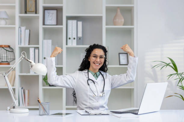istock Cheerful hispanic doctor celebrating success in office 2148317910