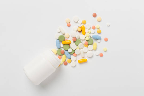 istock Jar with different medical pills and capsules on color background, top view 2148319783
