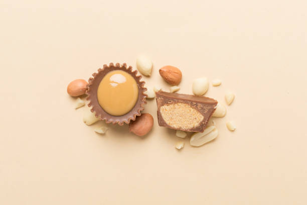 istock Tasty chocolate peanut butter cups on color background, top view 2148320165