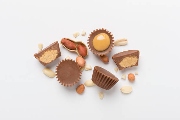 istock Tasty chocolate peanut butter cups on color background, top view 2148320170
