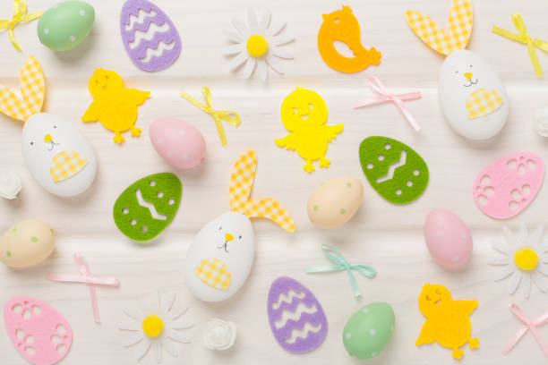 Easter eggs and decoration on wooden background, top view
