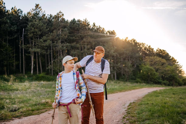 istock Father and son walking in nature in the spring looking on map where to go next 2148320796