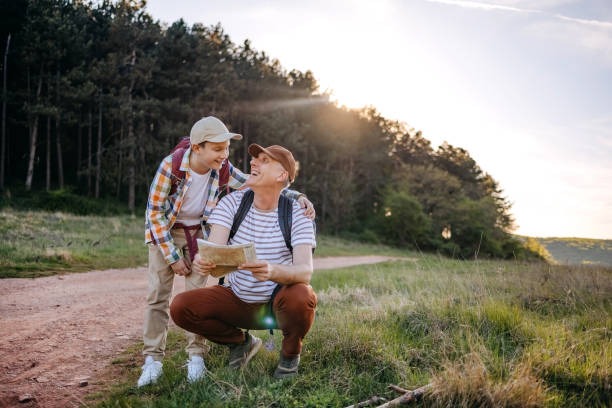 istock Father and son walking in nature in the spring looking on map where to go next 2148320809