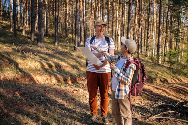 istock Father and son standing in nature in the spring looking for direction where to go 2148320953