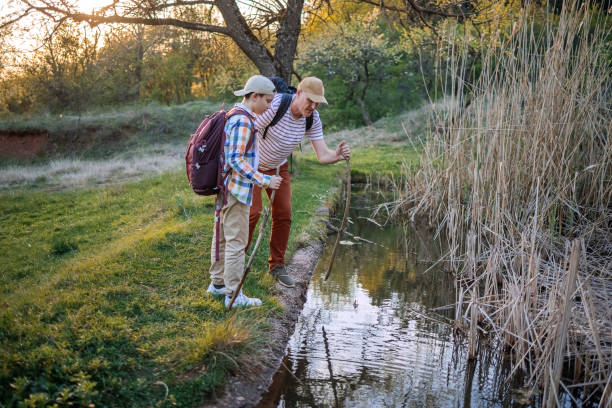 istock Father and son walking in nature in the spring finding water 2148321056