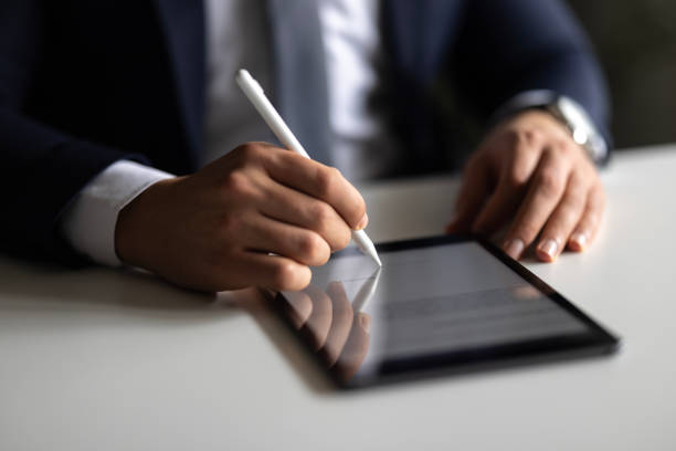 istock Businessman Signing Digital Contract On Tablet Using Stylus Pen 2148321135