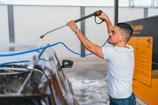 Witness the meticulous attention to detail as a skilled technician washes a car in a service center, using specialized tools and techniques to achieve perfection.