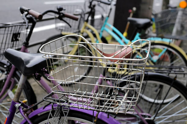 A group of bicycles lined up in a row on the sidewalk.