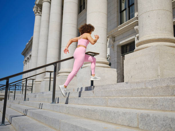 istock Woman Running Up Steps 2148322244