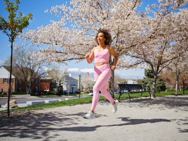 istock Woman Running Among Blossoms in Springtime 2148322542