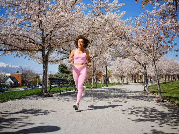 Woman Running Among Blossoms in Springtime