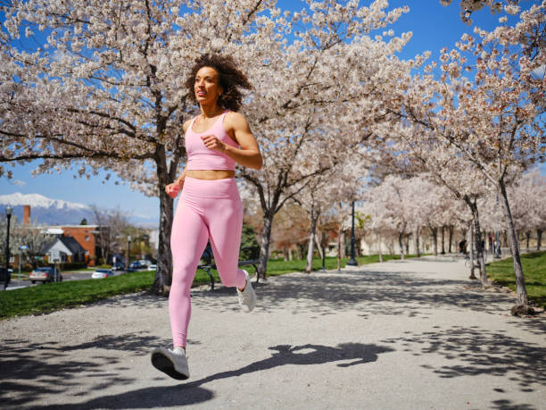 istock Woman Running Among Blossoms in Springtime 2148322583
