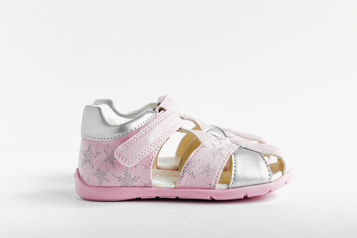 isolated children's pink summer sandals on a white background