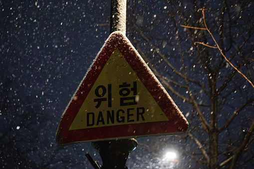 Danger Sign is on the Street under snowy day