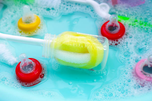 istock Wash baby bottles in plastic blue basin 2148323636