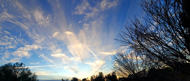 Abstract cloud formation and chem trails over California as the sun sets