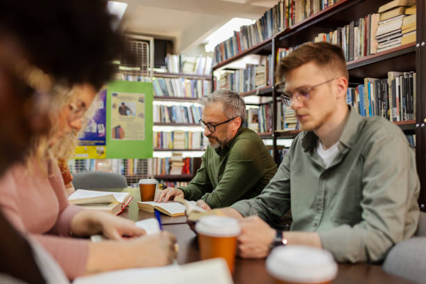 istock Group of Multiracial People Studying With Books in Library 2148325784