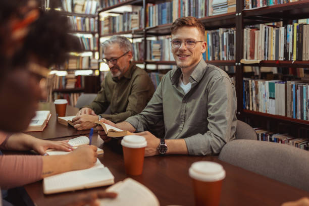 istock Male University Student Looking at Camera While Sitting in the Book Store 2148325924
