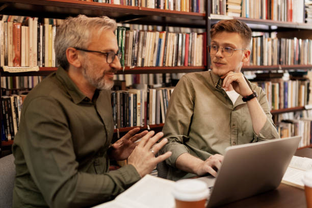 istock College Students Working in Library Being Helped by Tutor 2148326092