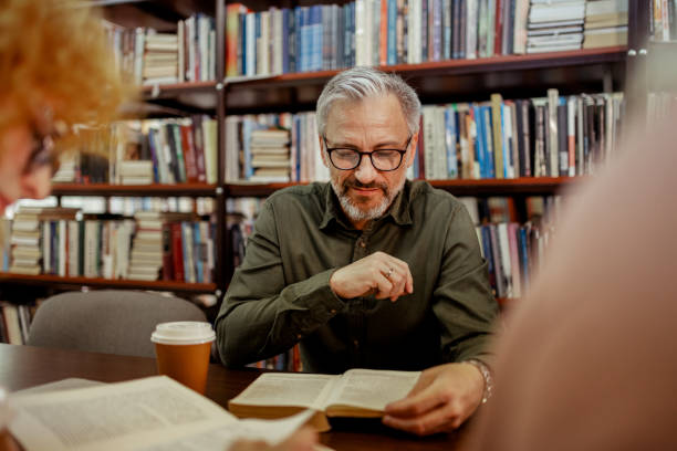 istock Mature Man Reading a Book at Library 2148326237