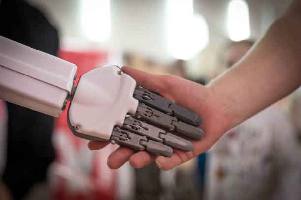 istock Person and robot shaking hands. Concept of human interaction with artificial intelligence 2148326365