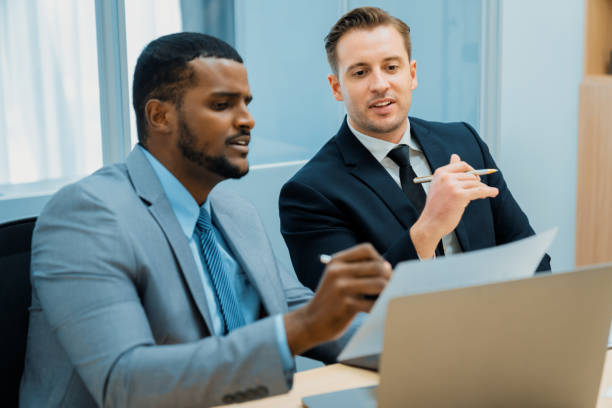 istock African male leader explain strategy while show solution to manager. Ornamented. 2148327031