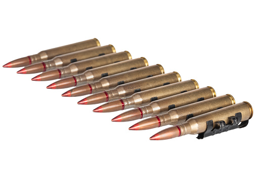 Ammunition belt with 12.7mm cartridges for heavy machine gun isolated on white background.
