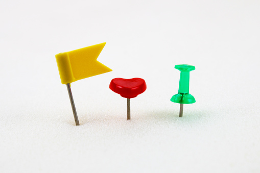 Thumbtacks of different colors and shapes