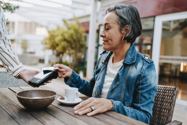 istock Mature woman making payment with credit card 2148331847