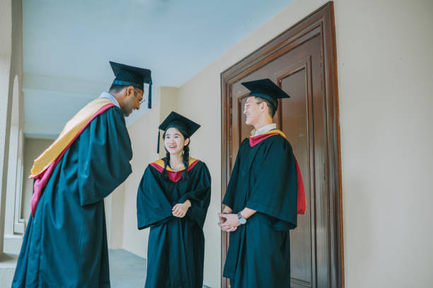 istock Asian graduation student waiting outside stadium talking at corridor 2148332074