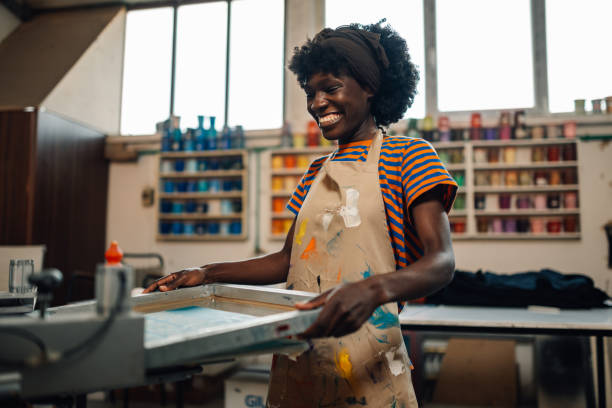 istock Happy interracial printing shop worker putting frame on printing press 2148332272