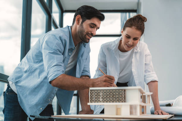 Smart architect engineer team working together to measure house model. Tracery. Smart caucasian architect engineer team working together to measure house model. Group of professional interior designer brainstorming and sharing ideas about design building construction. Tracery. architect stock pictures, royalty-free photos & images