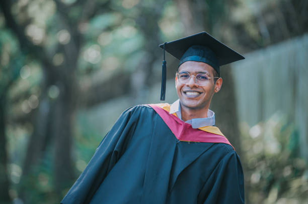 istock Asian Indian University student standing in public park looking at camera smiling 2148332362
