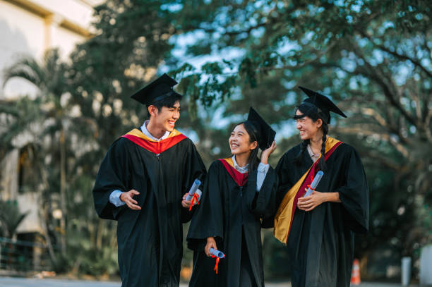 istock Exciting Asian graduation students holding diploma at campus outdoor 2148332745