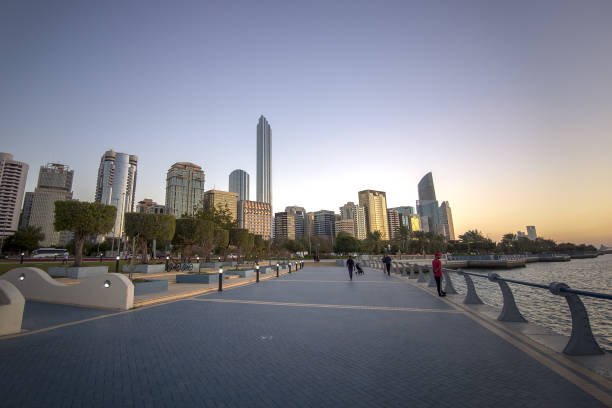 February 19, 2024, Abu Dhabi. United Arab Emirates: Abu Dhabi Corniche beachfront. people walk along the city embankment