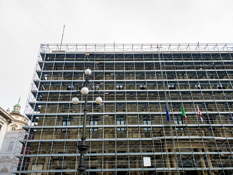 Photo of scaffolding outside of a old building in Europe.\nRestoration