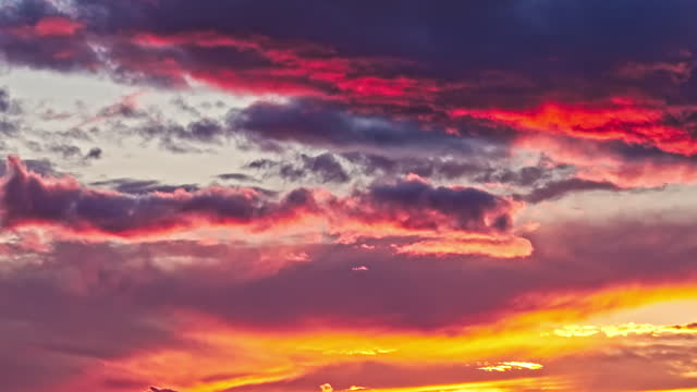 AERIAL Drone Shot of Red and Orange Clouds in Sky at Sunset