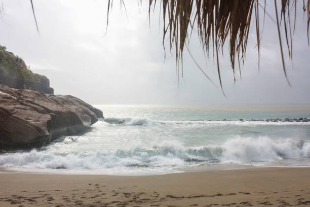 istock Tranquil rocky beach at dawn, waves crashing on shore, creating a mesmerizing scene for nature lovers and travelers seeking peace and serenity. 2148334322