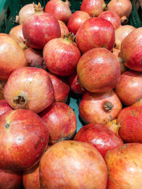 istock Fresh Pomegranates Displayed in Green Produce Crate 2148334496