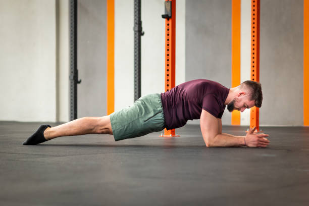 istock Determined man in sportswear doing calisthenics plank 2148339149